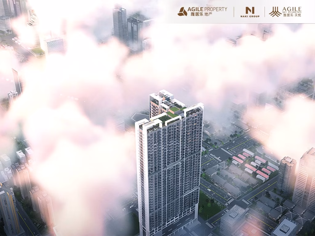 A tall modern skyscraper, Agile Sky Residence, rises above city streets and rooftops, partially shrouded in clouds, with logos for Agile Property and Naki Group at the top. The cityscape below features buildings and a grid of roads.