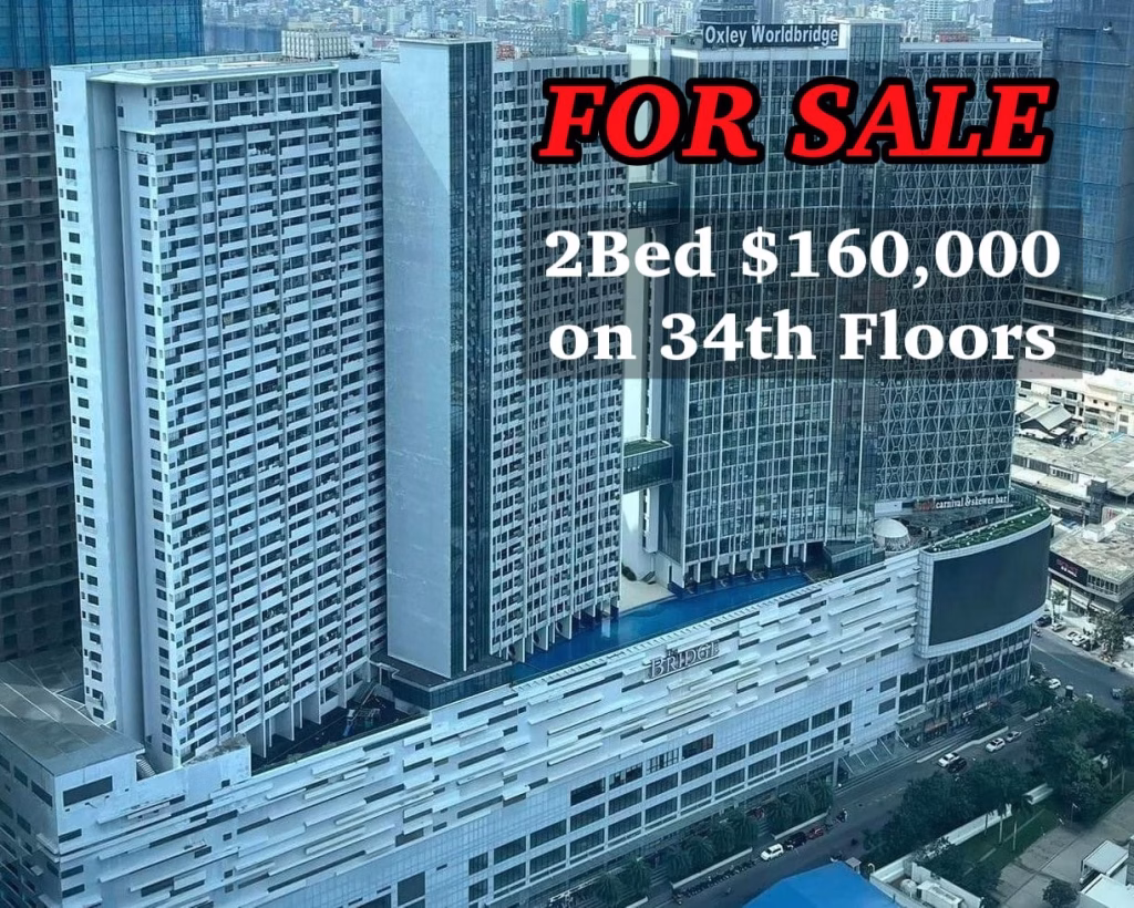 High-rise apartment building with a large FOR SALE sign, advertising a 2 bedroom condo for $160,000 on the 34th floor. The building is surrounded by other tall buildings in a vibrant cityscape.