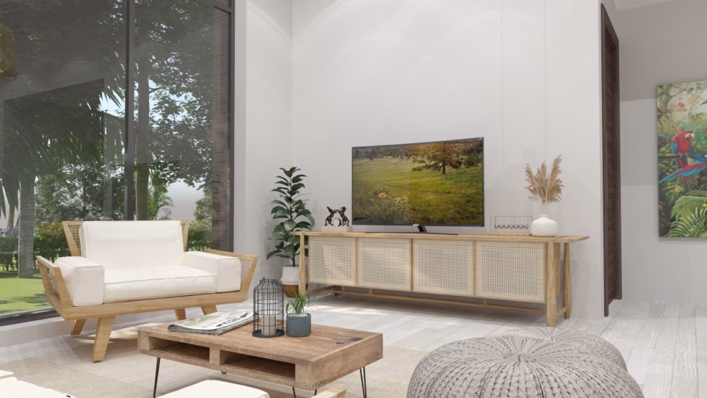 A modern living room with light wooden furniture, a TV on a wooden stand, potted plants, and nature artwork. Bright and airy with neutral tones, it’s the perfect setting to explore kampot homes for sale surrounded by greenery.