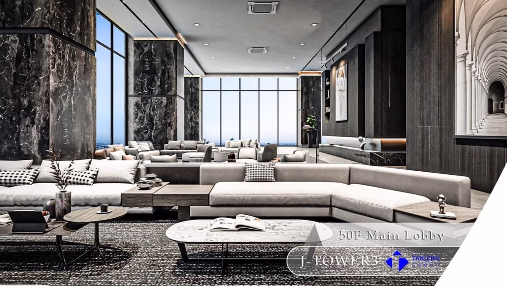 A modern, luxurious lobby with large windows, marble walls, stylish light gray sofas, and elegant décor welcomes you to the 3 bedroom apartment. The space is open and bright, with city views and contemporary design elements. Text reads 50F Main Lobby J-Towers.