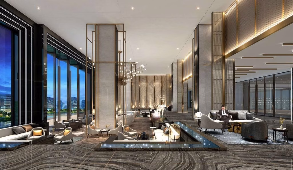 Spacious, modern hotel lobby with marble floors and tall windows offers riverfront luxury. Elegant seating areas, soft lighting, and gold accents create a luxurious and inviting atmosphere as guests relax on sofas and armchairs.