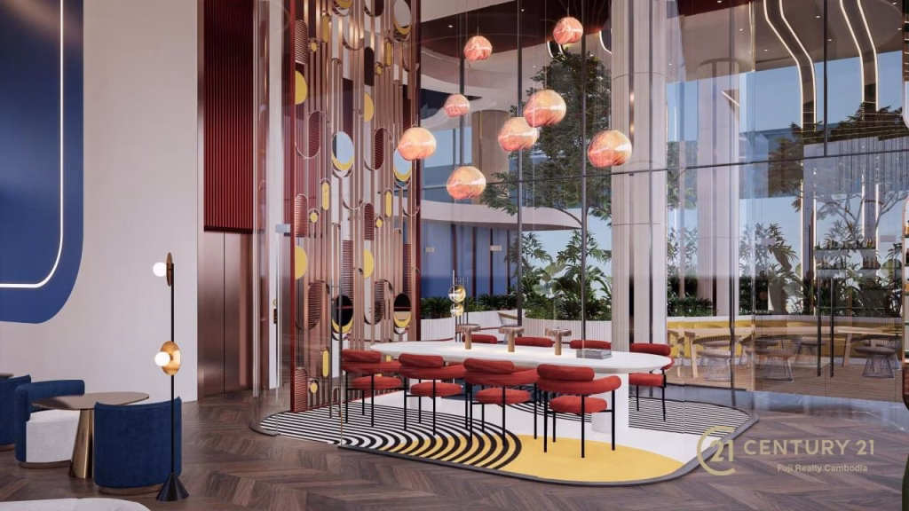 Modern lobby with a round table surrounded by red chairs, hanging pendant lights, floor lamps, and large glass windows. Decorative panels and a patterned rug add color to this Time Square 6-inspired space. Century 21 logo in corner.